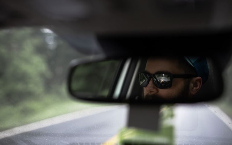 A rear-view mirror showing the road already travelled