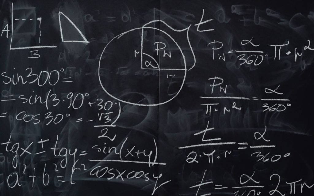 A blackboard crowded with chalk equations, running out of room