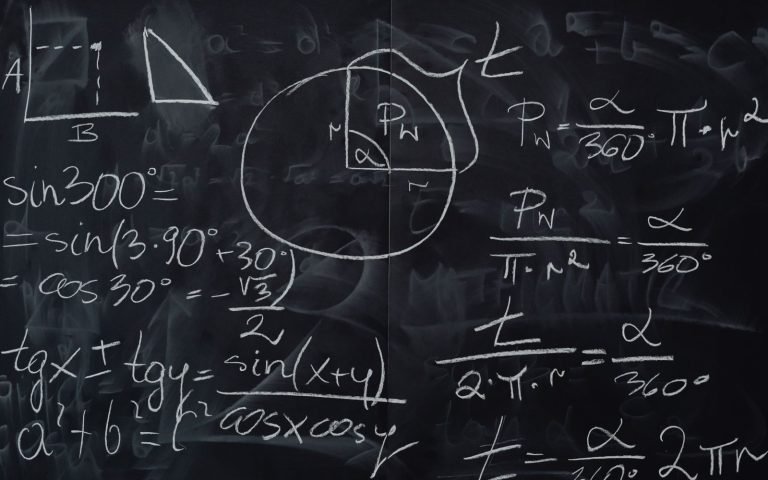 A blackboard crowded with chalk equations, running out of room
