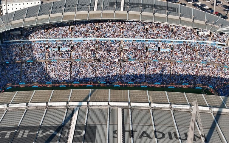 A packed stadium from above: fifty thousand and one rows