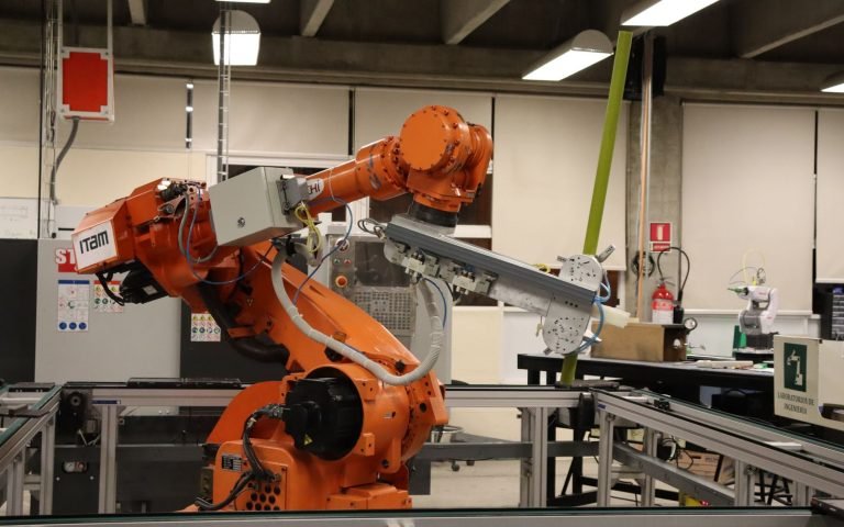 An industrial robot arm mid-weld: Flow handing the work to Apex