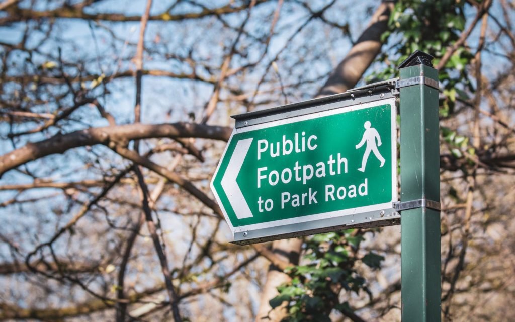 A right-of-way sign across private land: access granted by rule, not by ownership