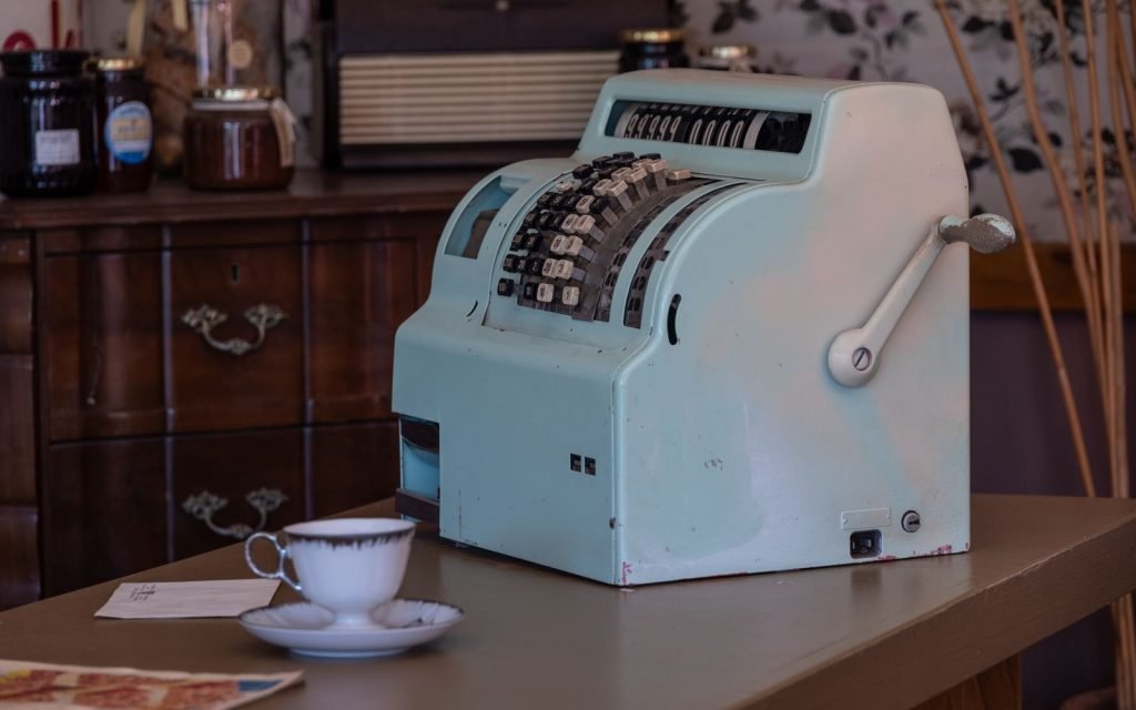 A mechanical adding machine totalling a column by hand