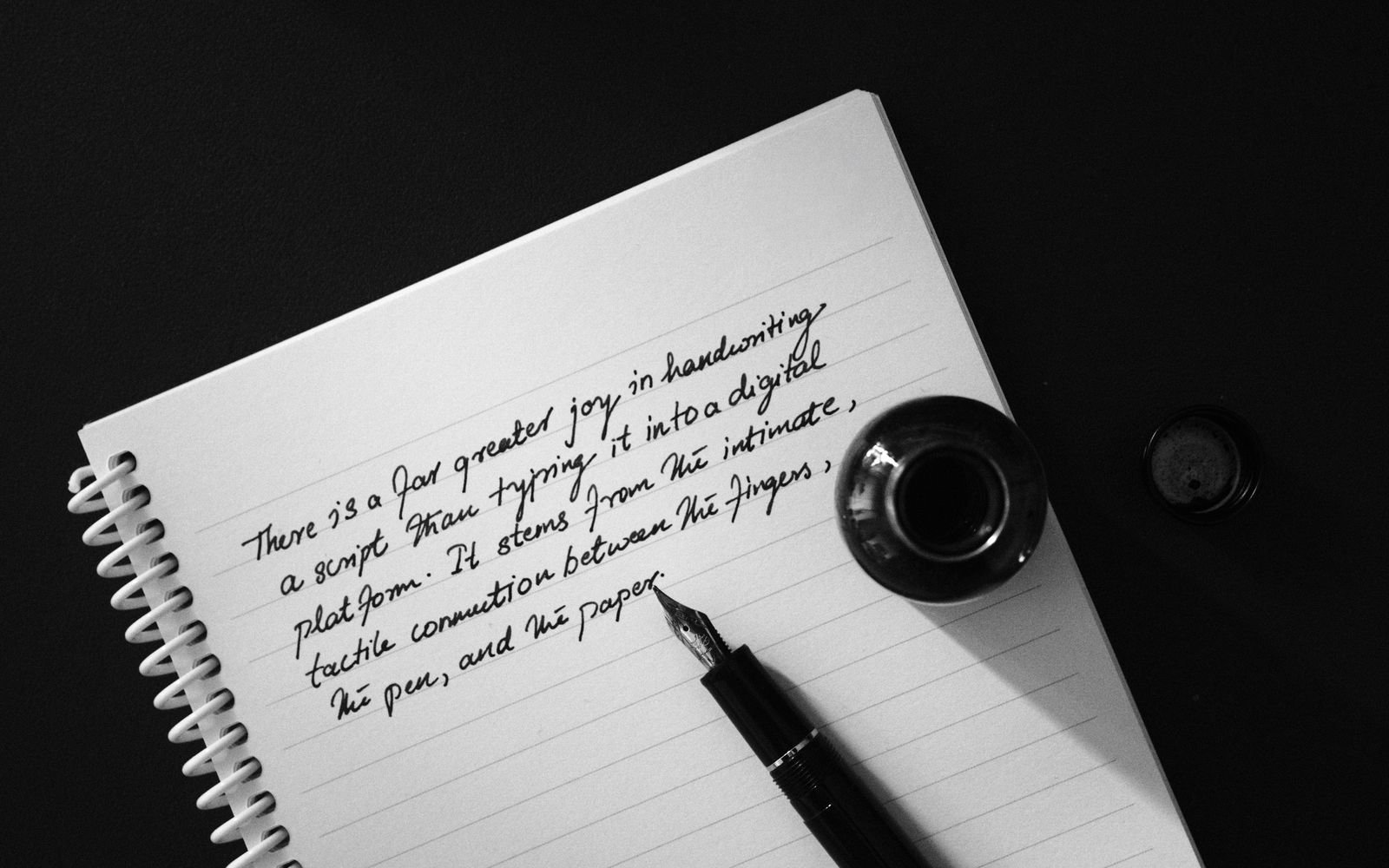 A fountain pen mid-sentence on a notebook page