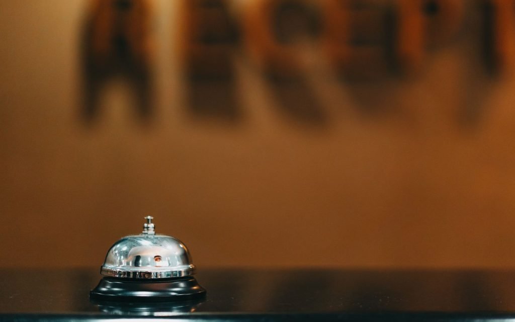 A front desk: one door in, and someone deciding what happens next
