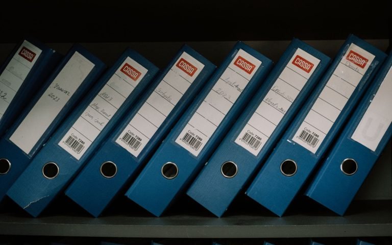 Labelled archive boxes on a shelf, each kept for a fixed term